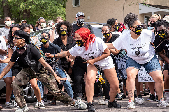A New Black City dancer leads the crowd.