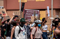 Protesters march past the Minneapolis police union offices.