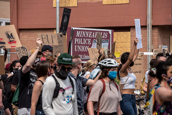 Protesters march past the Minneapolis police union offices.